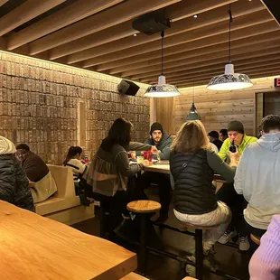 people sitting at tables in a restaurant