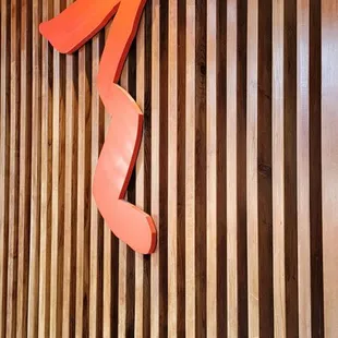 a wooden wall with a red arrow on it
