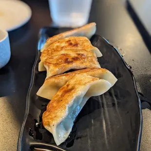 a plate of dumplings with sauce