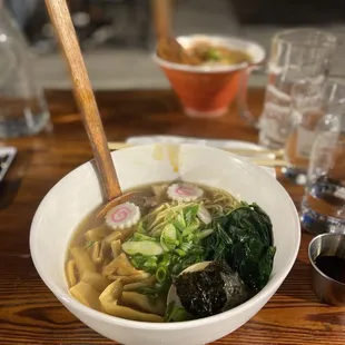 a bowl of ramen with broccoli