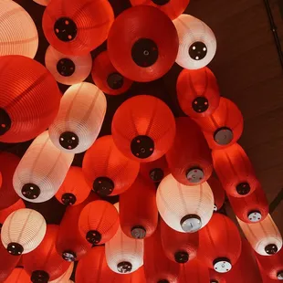 red and white paper lanterns hanging from the ceiling
