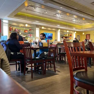 people sitting at tables in a restaurant