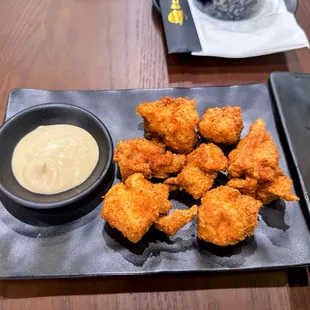 a plate of fried shrimp with a side of coleslaw