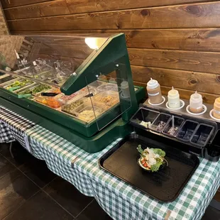 a buffet table with a salad bar