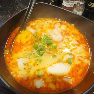 a bowl of ramen with a spoon in it
