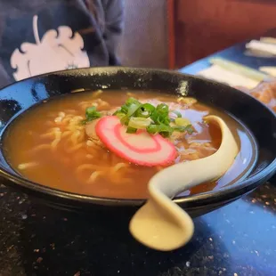 a bowl of ramen with radishes