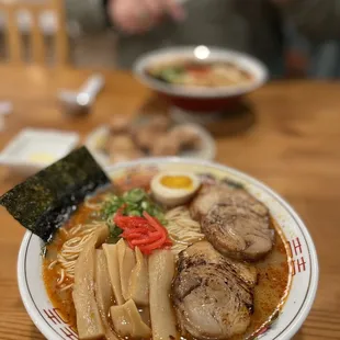 a bowl of ramen with meat and vegetables