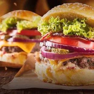 two burgers on a wooden table