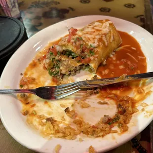 A wet Al pastor burrito with red salsa