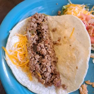 Ground beef has no seasoning. Corn tortilla doesn't hold shape and tasted like a flour tortilla. I did ask and was told it is corn.