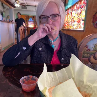 a woman eating a burrito