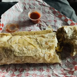 a burrito with a side of salsa