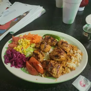 Grilled chicken over rice with a variety of vegetables. Chicken was cooked to perfection.