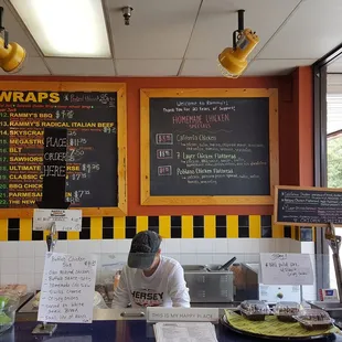 The owner/ manager preparing my sandwich.