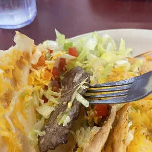 Half a very scrawny hamburger patty used for beef tacos.