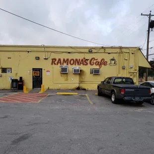 a yellow building with a sign that says ramona's cafe