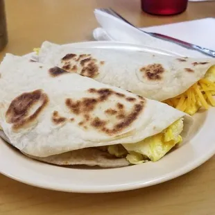 a breakfast burrito on a plate