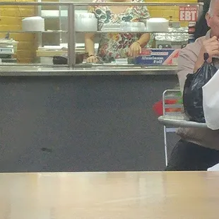 a man in a white shirt sitting at a table