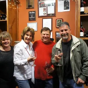 a group of people holding wine glasses