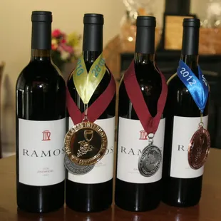 a row of wine bottles with medals on them