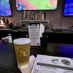 a pint of beer on a bar