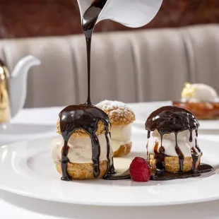 a dessert being drizzled with chocolate