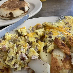 3 meat omelet with home fried potatoes and an English muffin