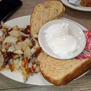 Perfect soft poached eggs with home fries and rye toast.