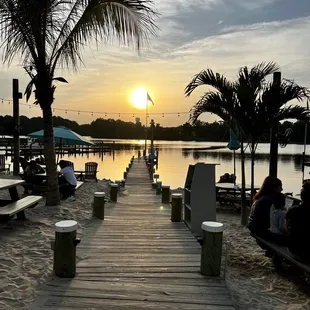 the sun setting over the water