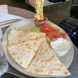 a plate of quesadillas and dips