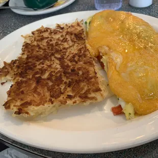 an omelet and hash browns on a plate