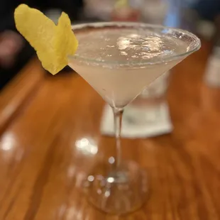 a martini with a lemon garnish