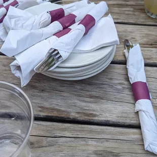 a table setting with napkins and forks