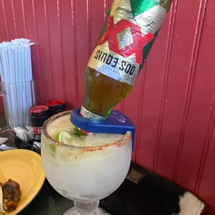 a margarita being poured into a glass