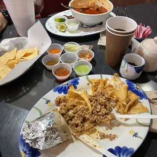 Breakfast burrito w coffee. Pozole with chips on the side.