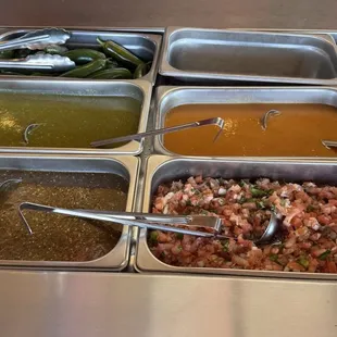 Salsa bar - dark red salsa in the front on the left is the hottest one -m