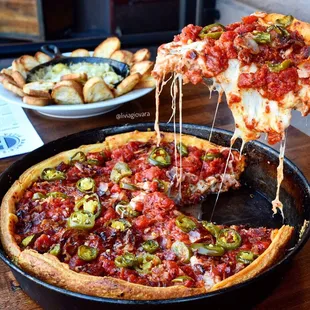Meatballs pizza and artichoke dip in the background
