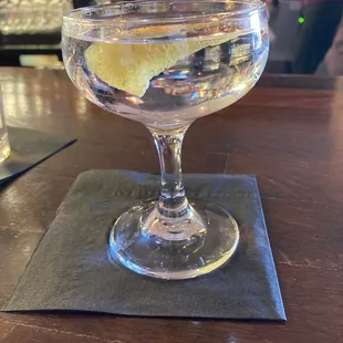 a glass of water with a lemon wedge in it