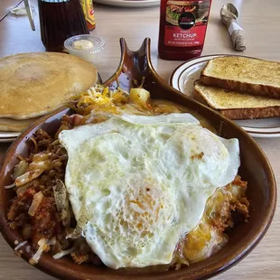 Chorizo Skillet, over easy eggs, with sourdough toast, and 2 pancakes.