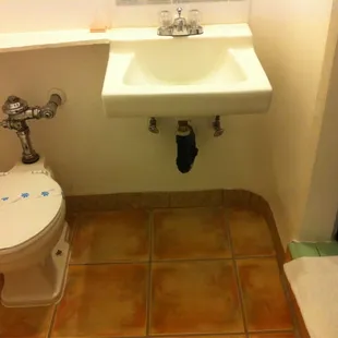 Bathroom. Sanitized toilet. Clean tile floor.