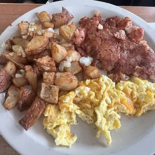 Corn, beef, hash, home, fries, scrambled eggs with cheese.