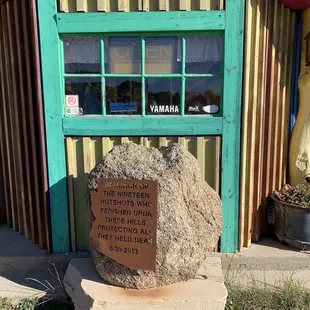 a large rock in front of a building