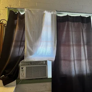 Instead of putting up a shorter curtain or just draping it over the AC...they used a towel. Classy.