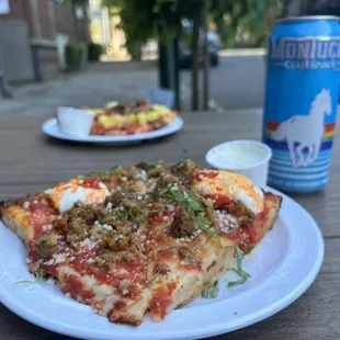 a slice of pizza and a can of soda