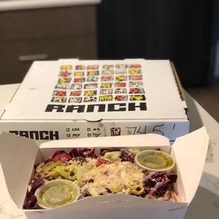 Radicchio Caesar salad and the pepperoni pizza in the box