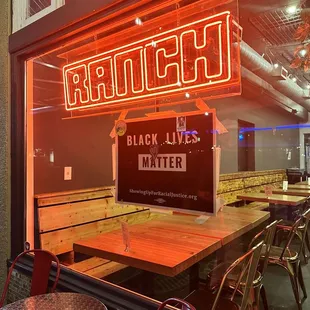 a neon sign in the window of a restaurant