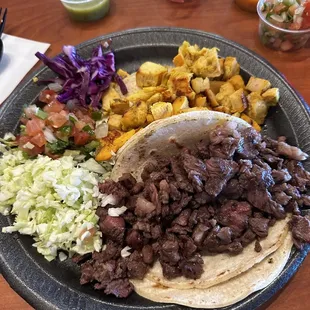 Carne asada and pollo tacos on corn tortillas