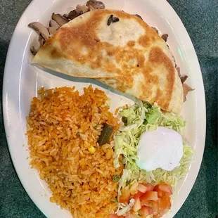 Cheese and mushroom quesadilla with salad and Spanish rice.