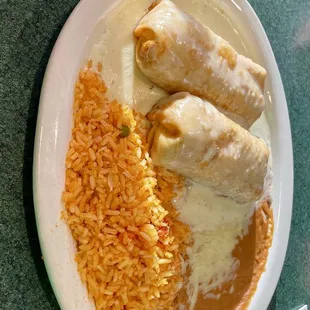 Chicken flautas with refried beans and Spanish rice.