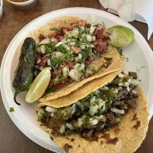 Carnitas and asada taco on two fresh tortillas